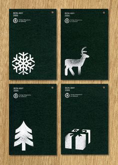 four black and white business cards with christmas symbols