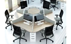 an office cubicle with multiple computer screens and desks, all in white and black