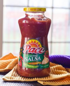 a jar of chili sauce sitting on top of a table