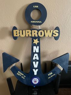 a wooden sign that says burrrows navy with an anchor