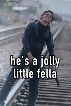 a man standing on train tracks with the words he's a jolly little fella