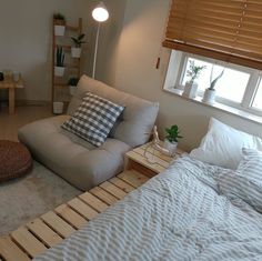 a bed that is made out of pallet wood and has pillows on top of it