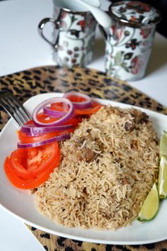 a white plate topped with rice and veggies