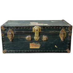 an old black trunk with brass handles and knobs on the handle is sitting in front of a white background