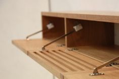 a wooden shelf with metal brackets on it