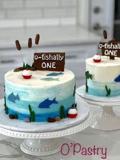 two cakes decorated with fish on top of each other