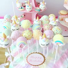 a table topped with lots of cupcakes and cake pops