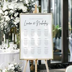 a table plan is set up on an easel in front of a floral centerpiece