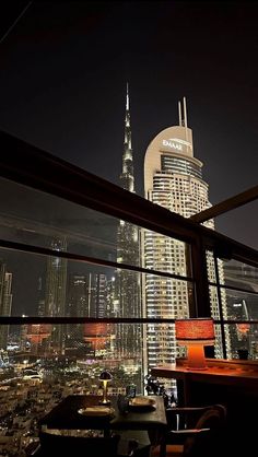 a view of the city at night from a restaurant