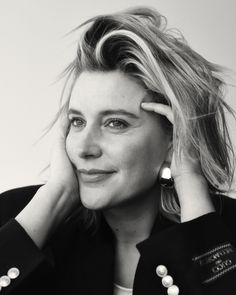 a black and white photo of a woman with her hand on her head