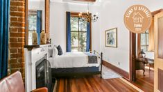 a bedroom with hardwood floors and white walls