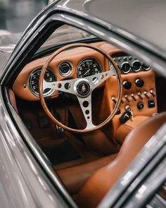 the interior of an old car with brown leather