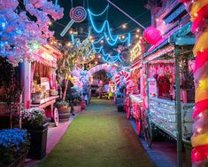 an outdoor market with lights and decorations