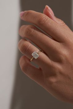 a woman's hand with a diamond ring on it