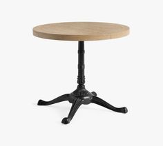 a round wooden table with black legs and an iron base on a white background, viewed from the front