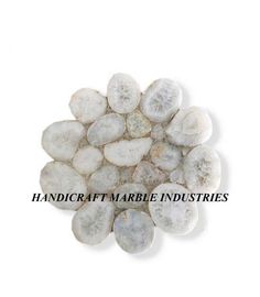 white marble pebbles with the words handicraft marble industriess on it's side