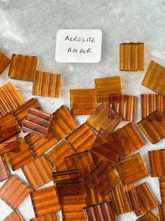 several pieces of brown glass sitting on top of a white countertop next to a sign that says absolute marble