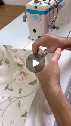 a person using a sewing machine to sew fabric