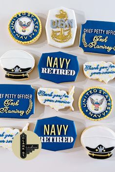 decorated cookies are arranged in the shape of navy letters and insignias, along with other decorations