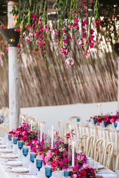 a long table with flowers and candles on it