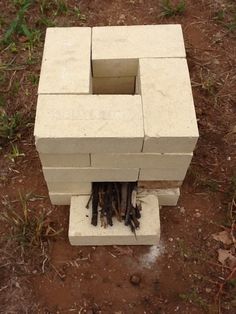 a cinder block sitting on top of a dirt field