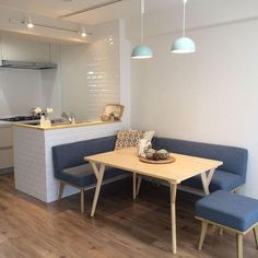 a kitchen with a table and benches in it