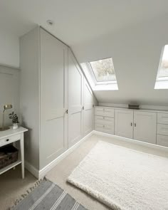 an image of a bedroom with white walls and carpet on the floor, in front of a window