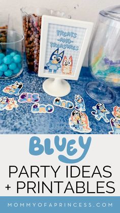 a blue table topped with lots of candy and candies