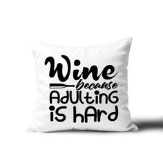 a white pillow with the words wine because adulting is hard printed on it, sitting against a white background