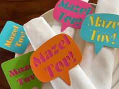 napkins with colorful speech bubbles on them sitting on a white plate, which says happy new year