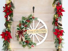 a christmas wreath hanging on the side of a wooden door with merry christmas written on it