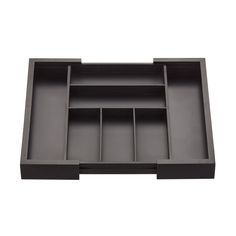 an empty black drawer with compartments on the bottom and one section open to show it's contents