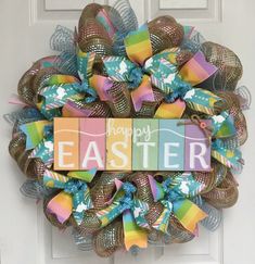 a happy easter wreath on the front door with colorful ribbons and letters that say happy easter