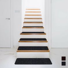 there is a set of stairs leading up to an open door in the hallway with carpet on the floor