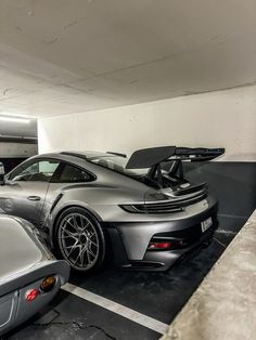 two cars are parked in a parking garage