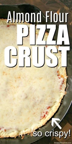 a close up of a pizza in a pan with the words almond flour pizza crust