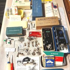 an assortment of sewing tools and other items laid out on top of a wooden table