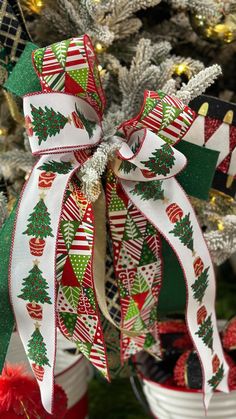 a christmas tree decorated with red, green and white ribbons