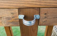 a wooden table with metal handles on it