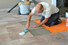 a man is painting the floor in his home