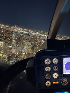 an aerial view of the city at night from a plane in flight with lights on