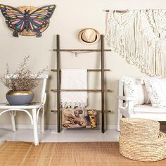 a living room filled with white furniture and lots of decor on top of the walls