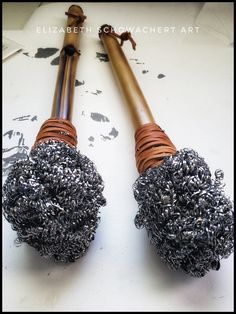 two large metal objects sitting on top of a white table next to each other,