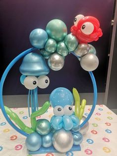 some balloons are in the shape of sea animals and jellyfishs on a table