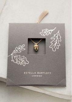 a necklace in a box with an animal's head on the front and bottom