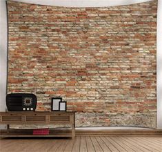 an old brick wall tapestry hanging in a living room with wooden floors and a coffee table