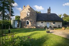 a house with a thatched roof in the countryside