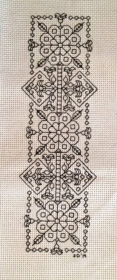 a cross stitch pattern with black and white designs on the bottom, along with an intricately designed border