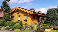 a yellow house surrounded by greenery and trees