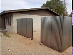 two metal gates in front of a house